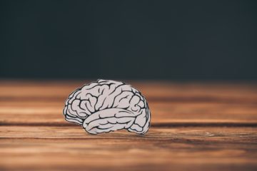 paper with brain as dementia symbol on black background